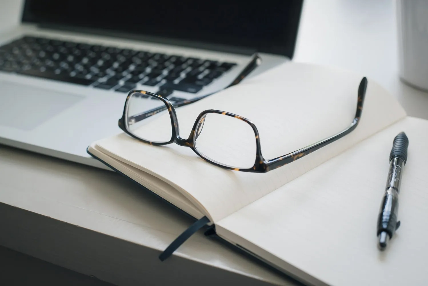 Laptop-with-Glasses-and-Notebook-1920w